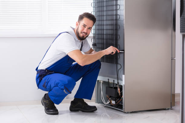 Fridge repair technician working